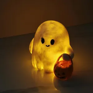 Glow detail of a cute ghost lamp holding a lit pumpkin basket for Halloween decor