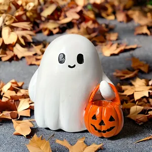 Cute resin ghost holding pumpkin basket figurine on autumn leaves Halloween decoration