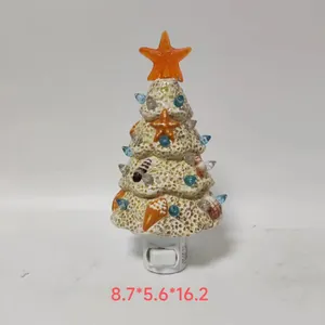 Detail of glowing starfish LED ocean Christmas tree light with coral shells and plug base