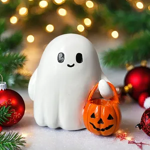 Detail of cute resin ghost holding orange pumpkin lantern with festive background lighting
