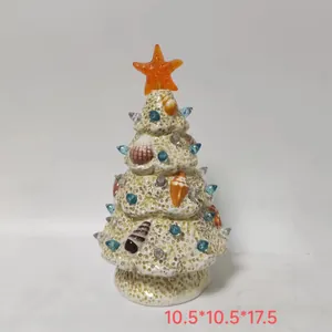 Detailed macro view of white resin coastal Christmas tree with sea shells and orange star