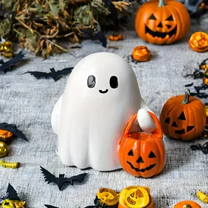 Detail of cute resin ghost holding a pumpkin basket for Halloween home decoration
