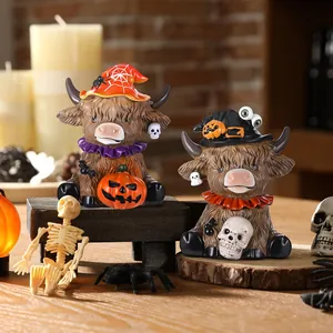 Detail of Halloween Highland cow figurines with wizard hats and pumpkin decor