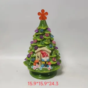 Ceramic Christmas tree figurine with colorful roses and gnome detail in a miniature doorway