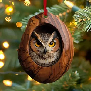 Close-up of owl Christmas ornament with realistic feathers and a red hanging ribbon