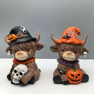 Detail of Halloween highland cow figurines with witch hats, pumpkin, and skull ornaments