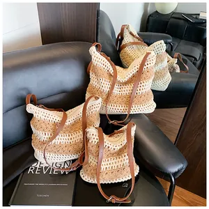 Detailed macro view showing three sizes of striped woven cotton beach bags on leather background