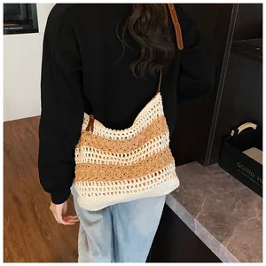 Detail of hand-woven striped tote bag with brown leather strap for summer beach vacation