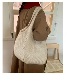 Detail view of large cream crochet tote bag showing woven texture on shoulder