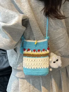 Handmade crochet crossbody phone bag for women with colorful stripes and plush charm