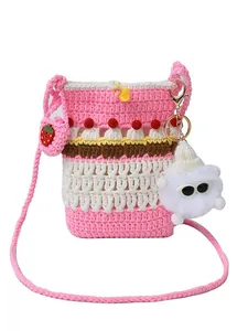 Pink and white striped crochet crossbody bag with strawberry charm and cute doll charm