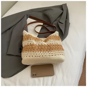 Detail of hand-woven crochet shoulder bag with brown leather strap and floral pattern