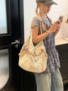 Chic cream crochet tote bag with ruffled edges and purple tulip charm for beach or daily use