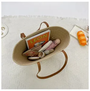 Detail view of large straw tote bag capacity with books and accessories inside