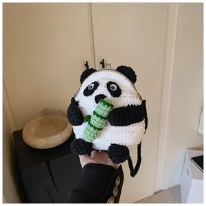 Close-up of handmade crochet panda bag showing metal clasp and green bamboo detail