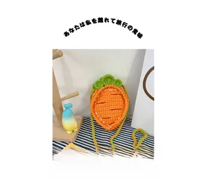 Detail of handmade crochet carrot bag featuring orange yarn texture and green leaf design