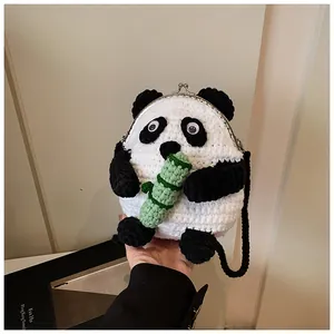 Close-up of handmade panda crochet bag featuring metal clasp and bamboo detail