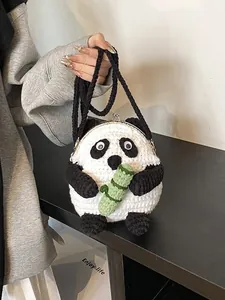 Detailed view of hand-crocheted giant panda crossbody bag with metallic clasp and bamboo leaf