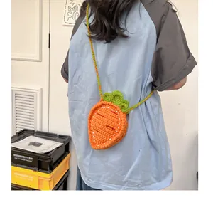 Rear view of a model wearing a handmade crochet carrot crossbody bag for children