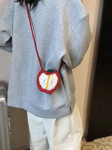 Girl's red apple-shaped knitted crossbody bag with a cute handmade leaf design