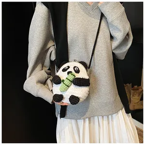 Handmade crochet panda crossbody bag with metal clasp shown on a model in daily outfit