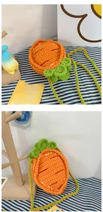 Close-up of handmade crochet carrot bag featuring knitted texture and green leaf detail
