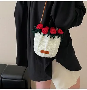 Detail of hand-crocheted bucket bag featuring a red rose and 'Hand Made' leather tag