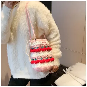 Detail of handmade crochet cherry bucket bag with Sweet Cherry tag and pink drawstring strap