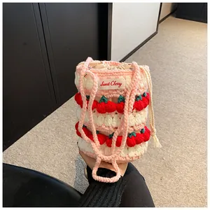 Detail of handmade crochet bucket bag with cherry decor and Sweet Cherry label