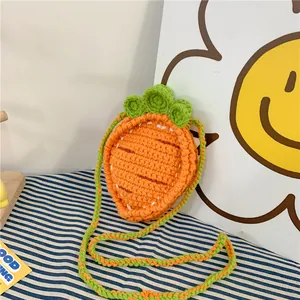 Macro detail of hand-knitted carrot bag showing textured orange crochet stitch and green leaf
