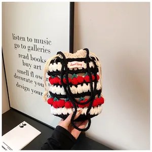 Detail of handmade crochet cherry bucket bag with woven patterns and drawstring closure