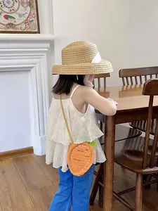 Handmade crochet carrot shoulder bag for kids with green leaf detail and colorful strap