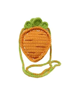 Handmade crochet carrot crossbody bag for kids with orange knit texture and green leaves