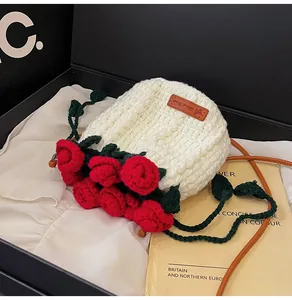 Detail view of handmade crochet rose bouquet bucket bag with leather strap and handmade label
