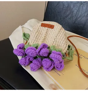 Close-up of handmade crochet bucket bag with purple rose detail and leather label