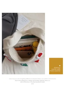 Spacious interior of white knit Christmas tote bag showing daily items like an umbrella