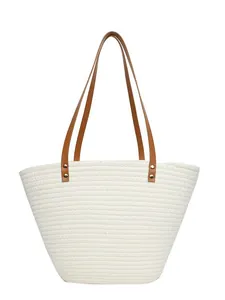 Large white woven straw tote bag with brown leather handles for summer beach vacations