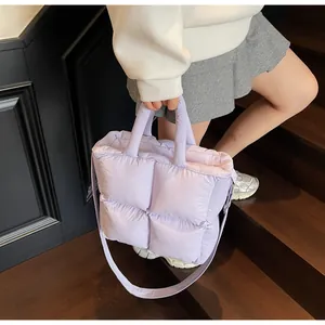 Detail of light purple quilted puffer tote bag with soft texture and chic square padding