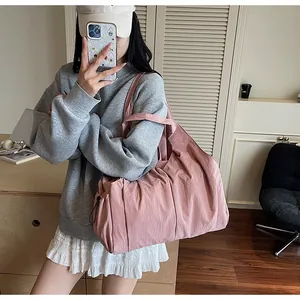 Close-up of pink oversized tote bag with drawstring side details and pleated texture