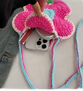 Detail view of handmade crochet flower bag showing inner space for phone and lipstick