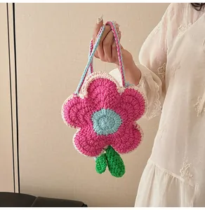Detailed close-up of handmade crochet flower bag with intricate knit texture