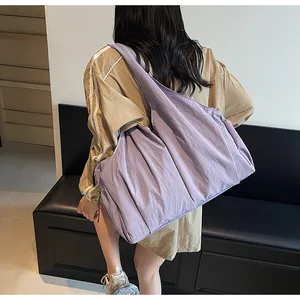 Detailed view of light purple pleated tote bag showing large capacity and soft nylon texture