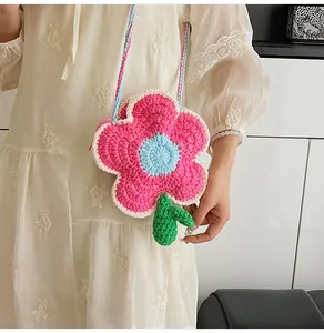 Detail of handmade crochet flower crossbody bag showing pink petals and leaf texture