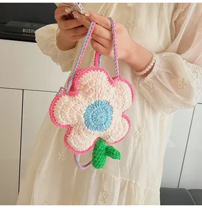 Detail shot of a handmade crochet flower shoulder bag in pink and blue yarn