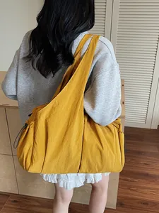Minimalist mustard yellow oversized pleated shoulder bag in durable nylon fabric