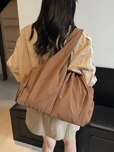 Deep brown ruched hobo bag with wide shoulder strap in a minimalist crossbody style