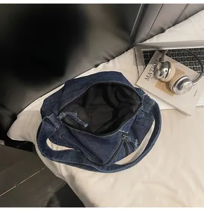 Top view of large capacity denim tote bag showing black zipper and spacious interior