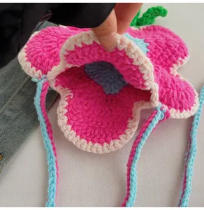 Detail view of the handmade strawberry knit bag's inner compartment and woven texture