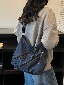 Retro denim tote bag with frayed edges and zipper pockets for casual commuting