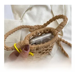 Detailed internal view of woven straw phone bag showing capacity with a smartphone